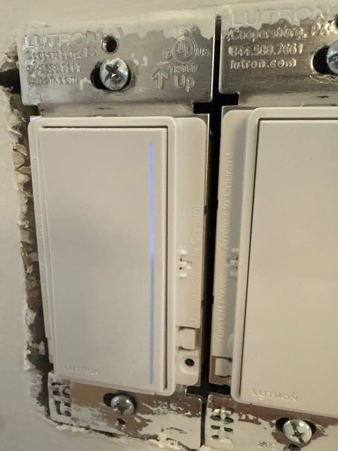 Smart lighting dimmers installed in a wall box