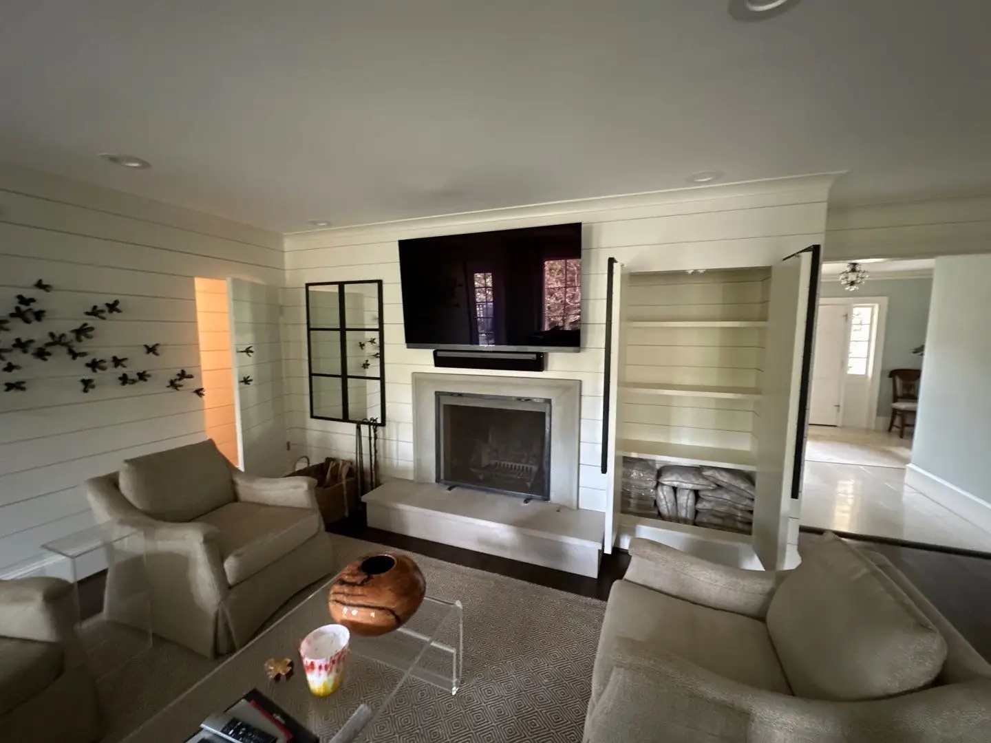 Living room TV above a fireplace between built-ins