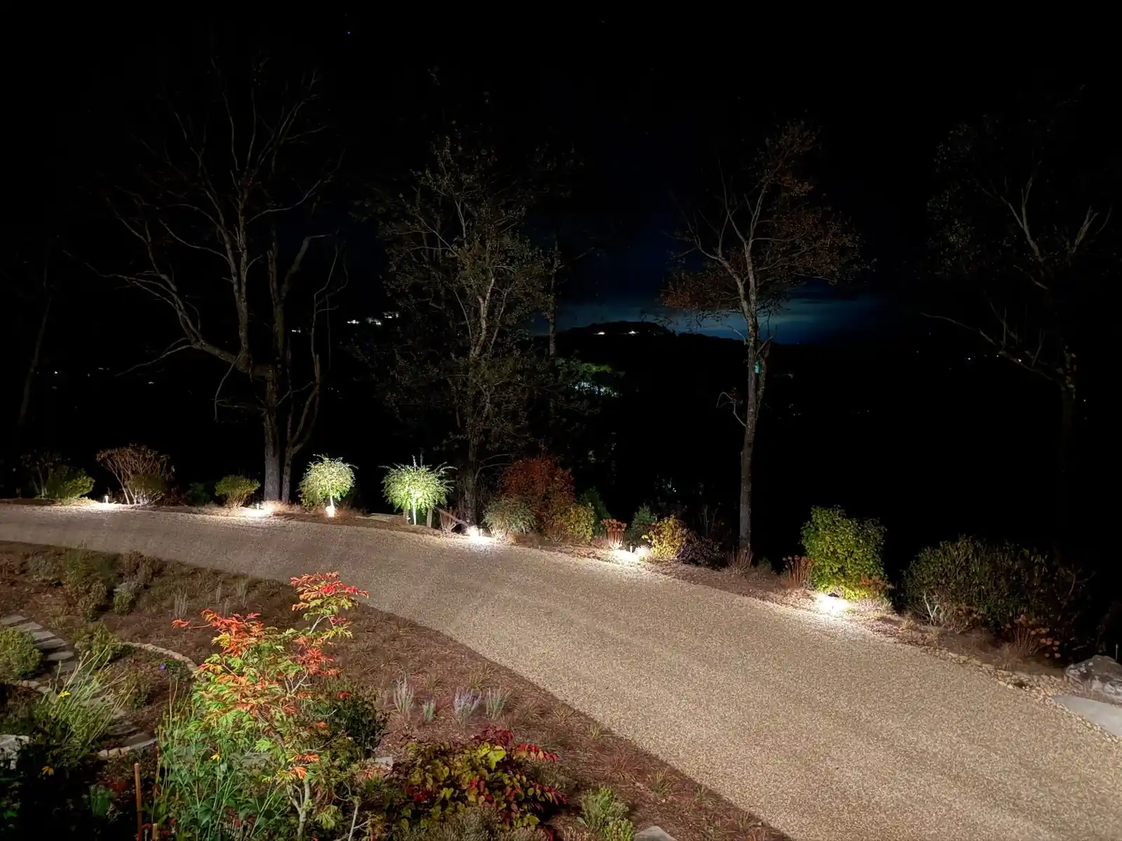 Curving gravel driveway lined with path lights