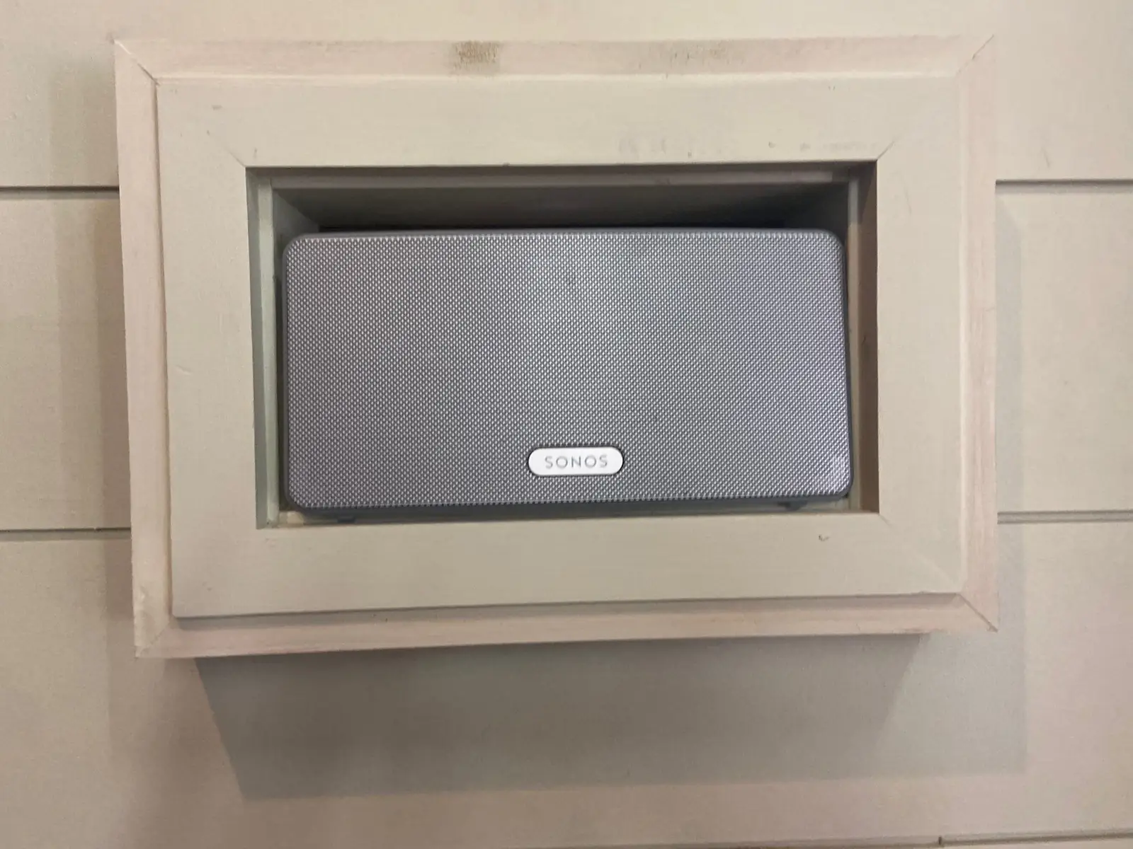 Center channel speaker set into a trimmed wall niche
