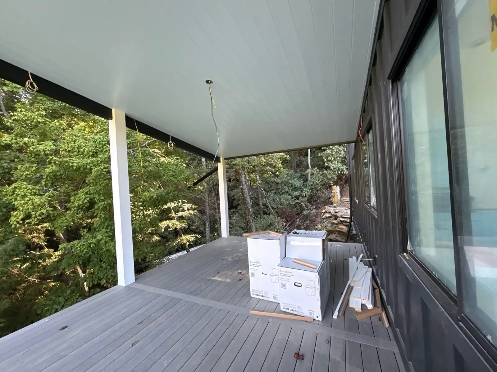 Covered porch prewired for outdoor speakers overlooking Lake Rabun