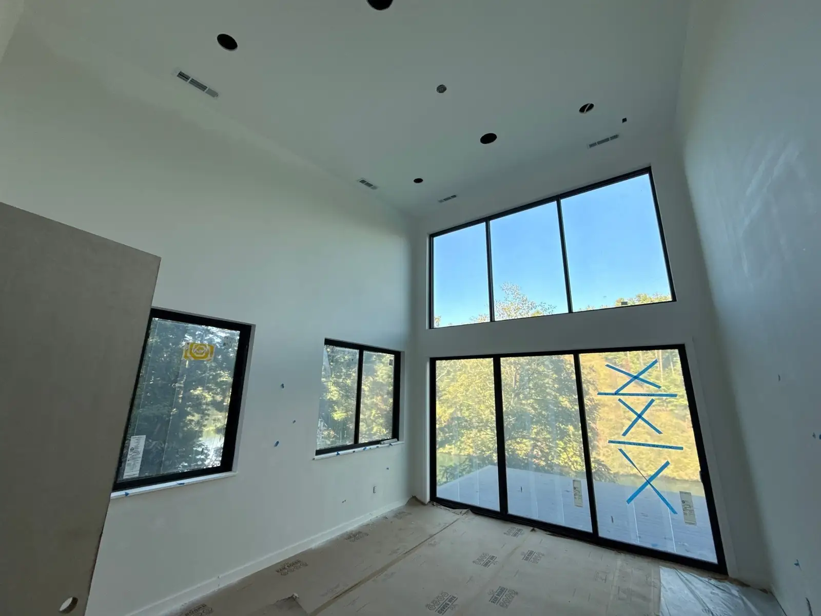 Modern lake home living area with floor-to-ceiling windows